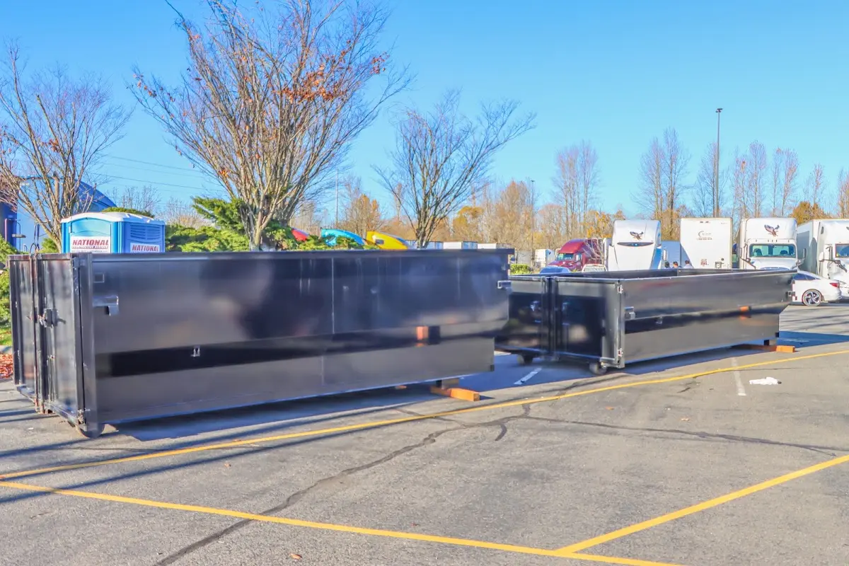 Professional dumpster rental service with roll-off container on residential driveway in Spanaway